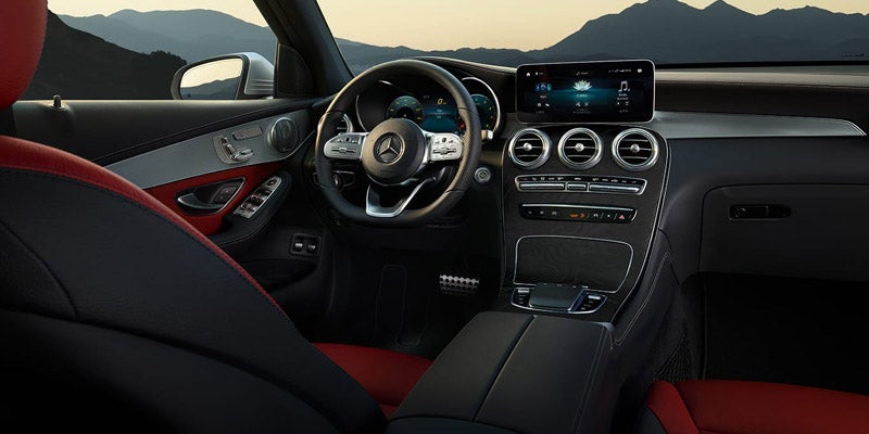 View of the modern Mercedes-Benz dashboard and steering wheel from driver's side.