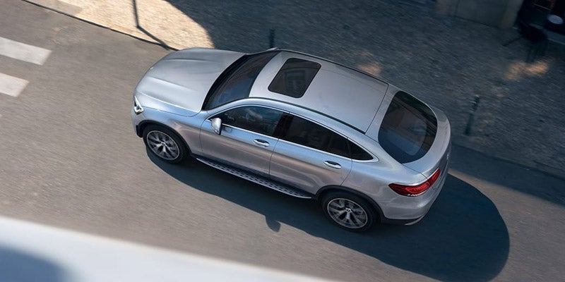 High-angle bird's-eye view of a silver Mercedes-Benz SUV parked outdoors