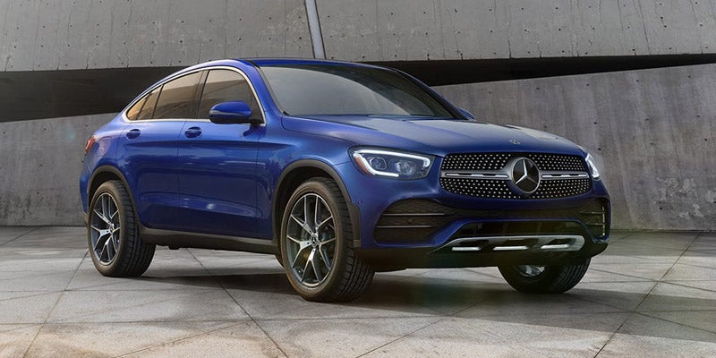 Low-angle front view of a blue Mercedes-Benz SUV in a garage