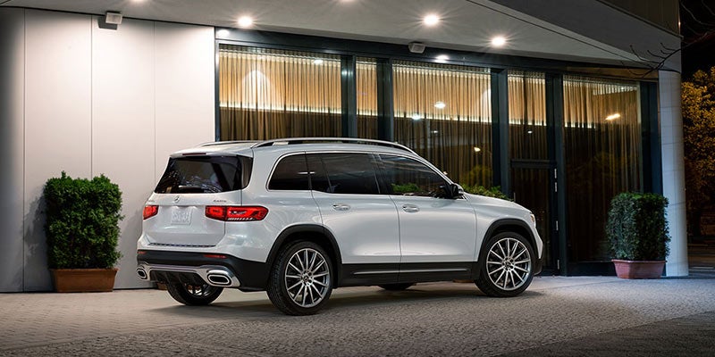 Rear three-quarter view of a white Mercedes GLB parked at night.