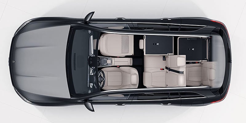 Overhead bird's-eye view of a car's interior with beige leather seats