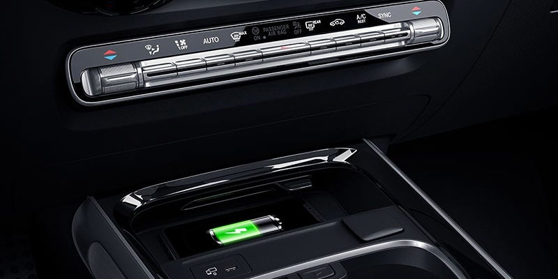 Close-up of a smartphone charging on a wireless charging pad.