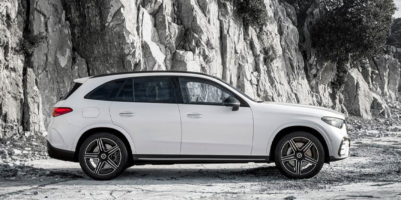 Side profile view of a white Mercedes-Benz GLC SUV.