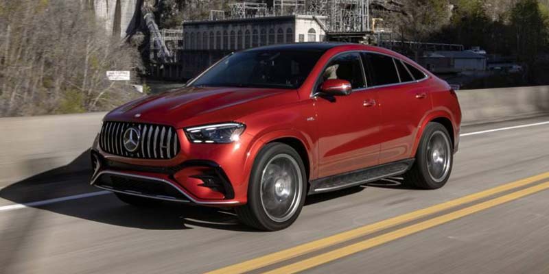 Red Mercedes-Benz GLE Coupe driving on a coastal road