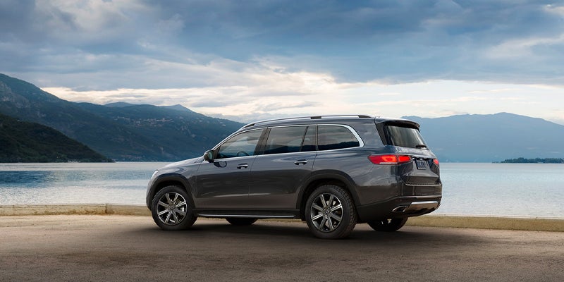 Profile view of a gray Mercedes-Benz SUV on a paved surface.