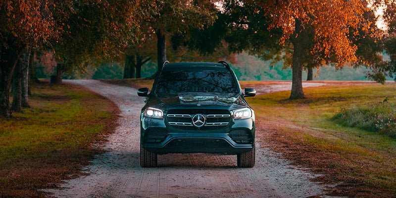 Three-quarter view of a navy blue Mercedes-Benz SUV outdoors.