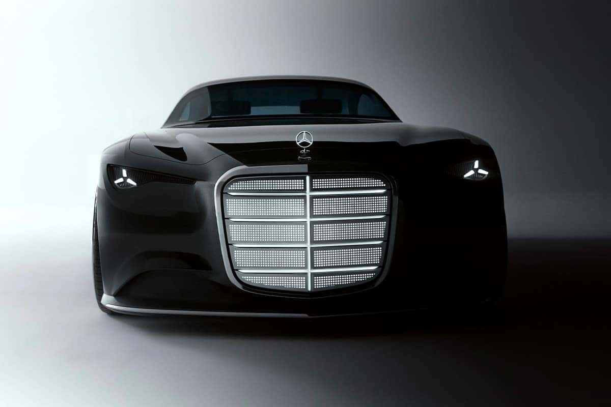 Front view of a sleek black luxury car with a large chrome grille in a dim studio setting.