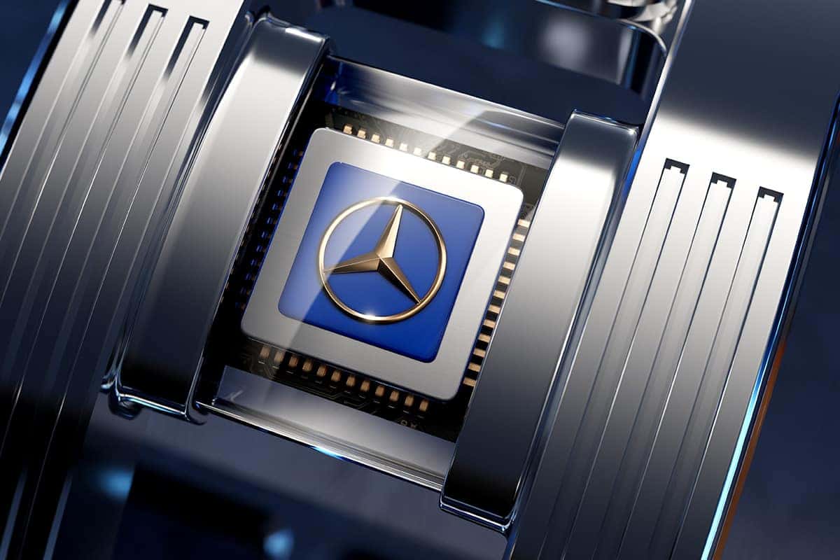 A close-up of a metallic Mercedes-Benz logo on a blue microchip, surrounded by metal fins.